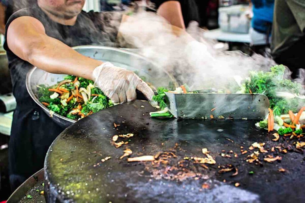 Grilling vegetables at street vendor in Asia