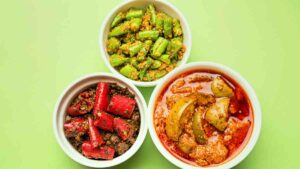 Three bowls of green and red pickles for Asian food