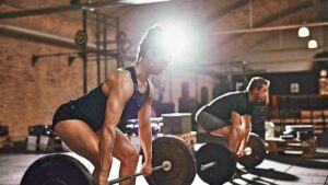 Indoor workouts with personal trainer at the gym.
