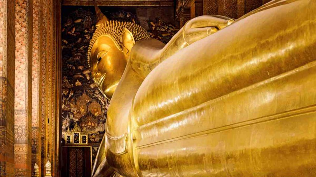 Golden plated luing Buddha in Tample in Thailand.