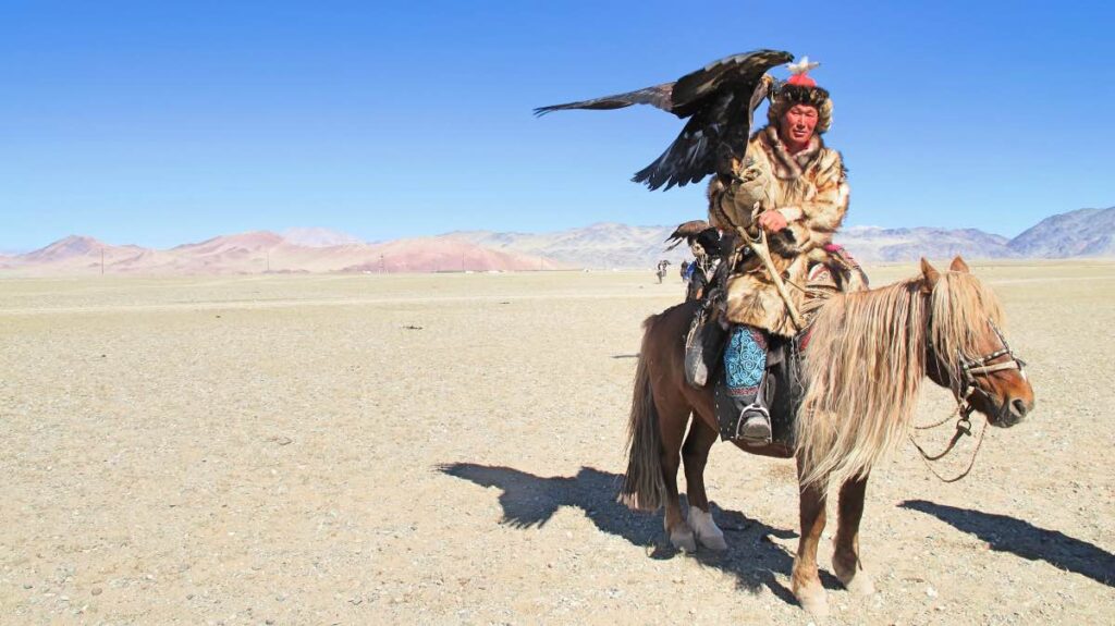 Man on a horse in Mongolia holding an eagle