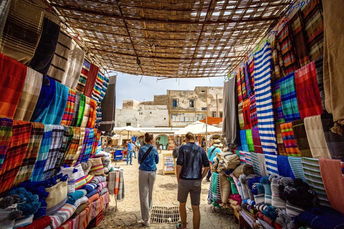 marrakhech tourists walking through moroccan market