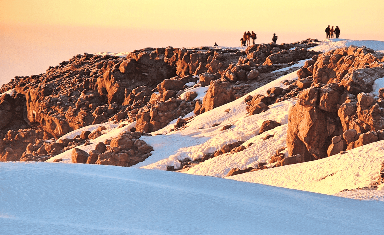 private group of hikers on the summit of Kilimanjaro atdawn